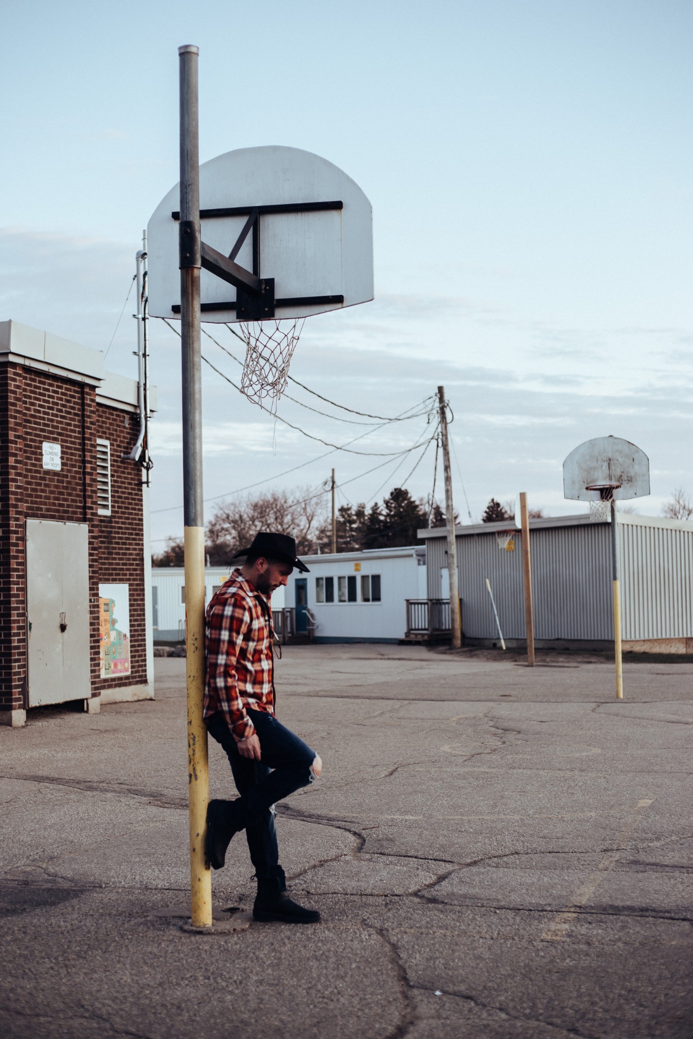 Country-rock promotional portrait on an outdoor court