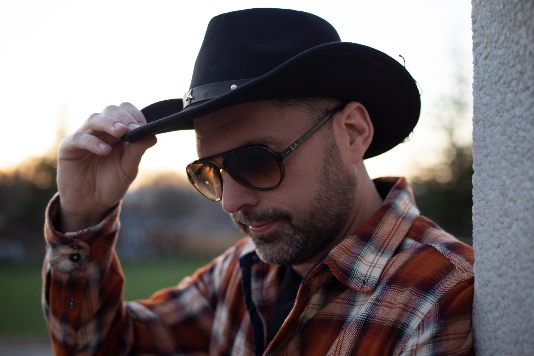 Close-up artist portrait in cowboy hat and sunglasses
