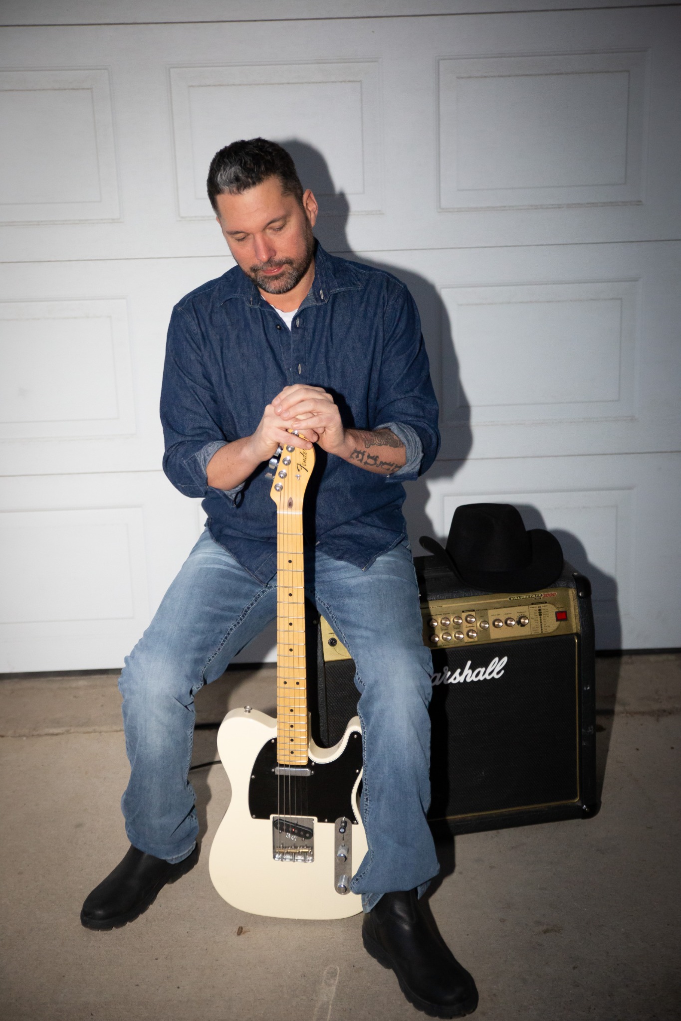 Lance Clyne with electric guitar and amplifier